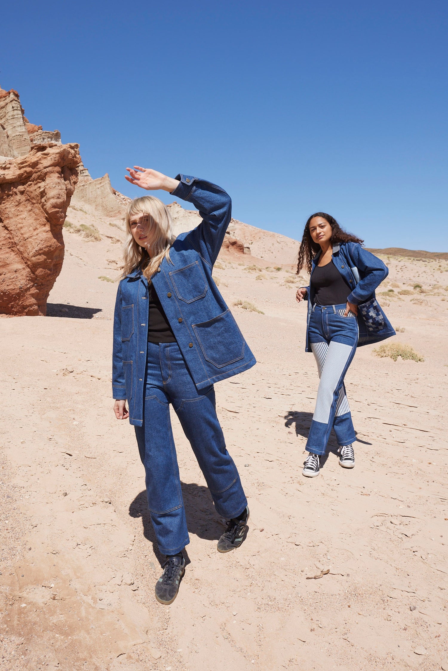 two friends explore the mojave desert in matching denim jackets and workwear jeans