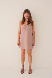 Woman wearing a pink dress against a white background